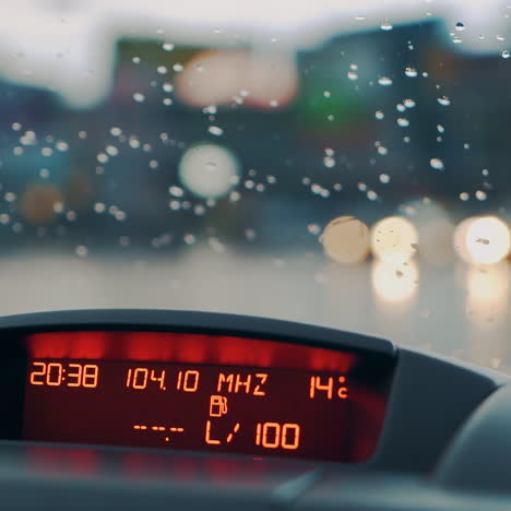 raindrops fall on the windshield of the car. inside view. car dashboard. close-up