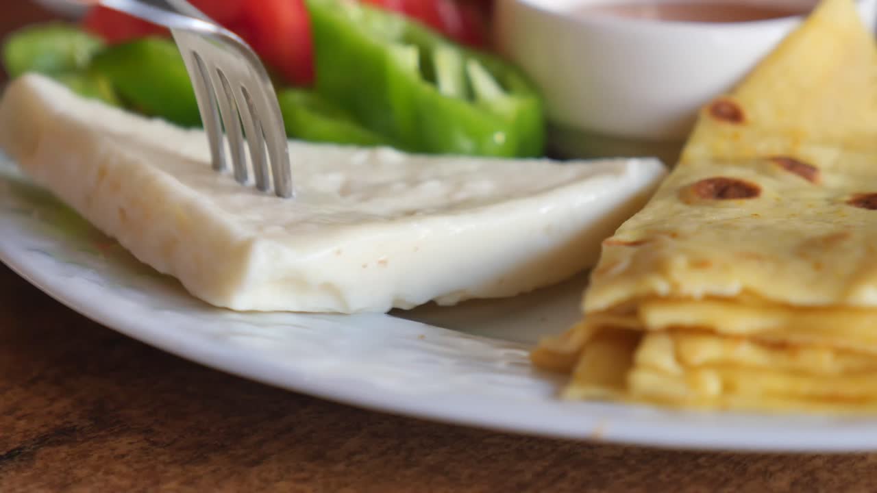 A delicious breakfast of pancakes, vegetables and cheese