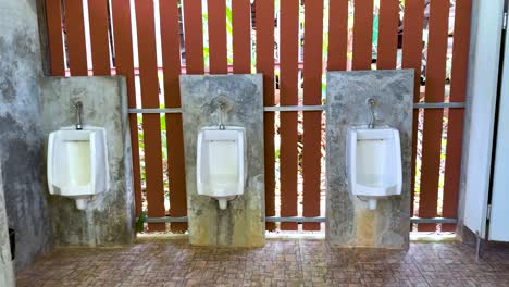 empty male restroom with urinals and sink