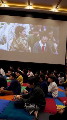 children watching a movie in a school library