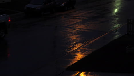 truck drives on wet street during rain at night