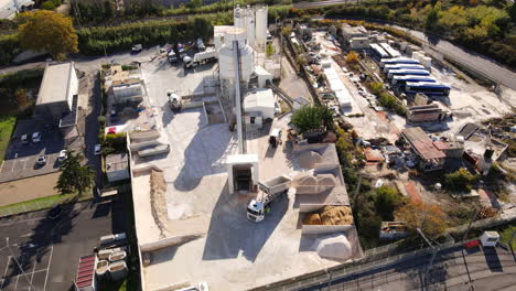 overhead shot of a bustling montpellier construction area with silos, trucks