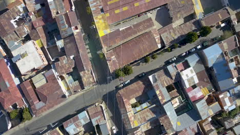 Aerial-view-following-cable-cars-revealing-the-dense-La-Paz,-Bolivia-cityscape