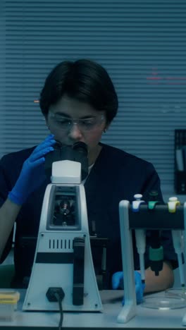 scientist using a microscope in a laboratory