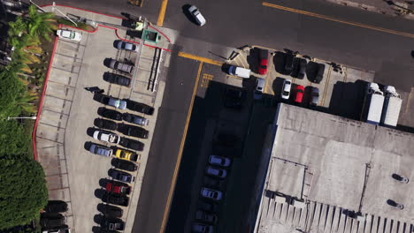 aerial view of urban intersection and parking lot with vehicles