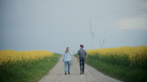 Farmer-With-Agronomist-On-Road-Amidst-Plants-At-Farm