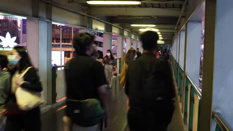 people walking through a sheltered urban passageway