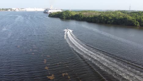 drone flight behind a jetsky traveling over the water