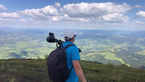 a man photographs a mountain landscape while hiking in the mountains a man photographs a mountain landscape while hiking in the mountains nature photography