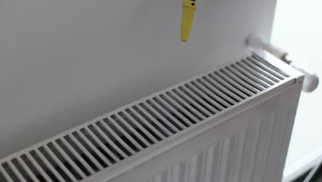 cleaning a white radiator with a cleaning device