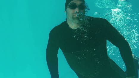 athletic man swimming underwater