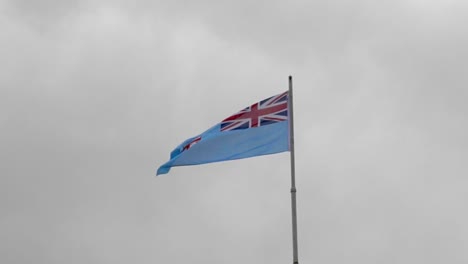 the republic of fiji national flag flying over the parliament building