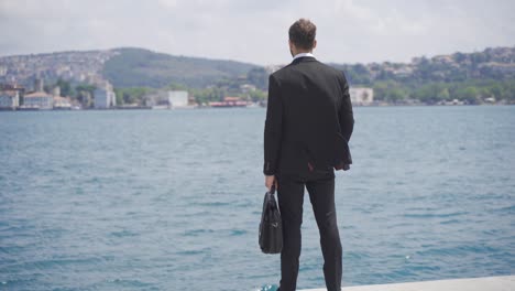 businessman rejoicing against the ships in the city strait.