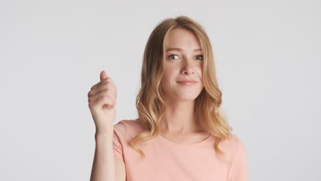 caucasian woman showing you and me gesture on camera.