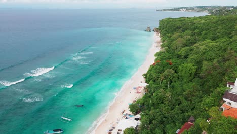 drone scene of perfect beach in uluwatu located down the cliff, bali, indonesia