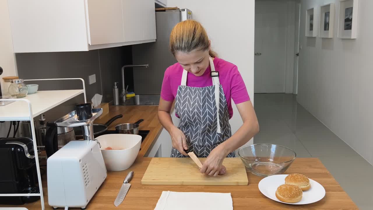 mujer preparando pollo para hamburguesas