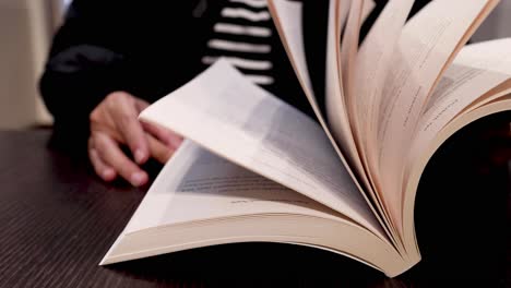 person flipping through a book's pages