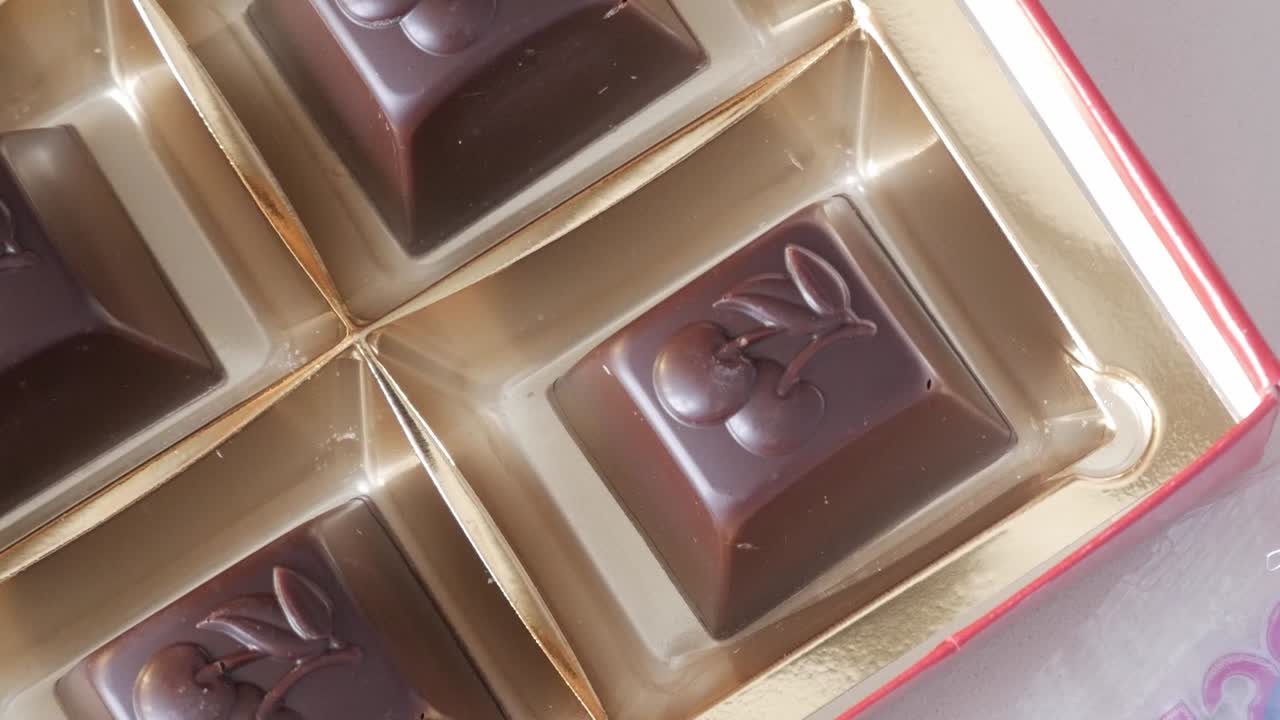 Chocolate pralines in a box with elegant golden packaging for Valentine's Day
