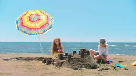 children building sandcastles on the beach