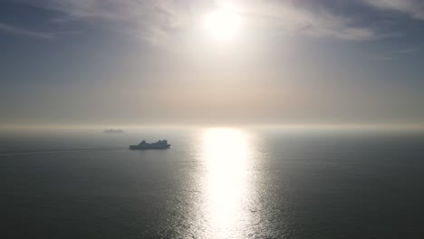 silhouette of cruise ship navigating on silver sea water