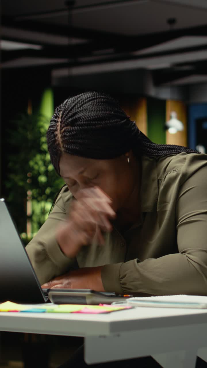Vertical Video African american drained woman experiencing weariness after hours at desk