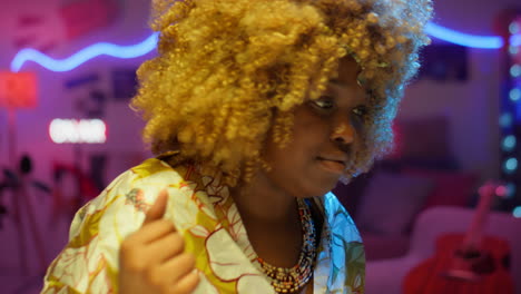 woman with curly hair in a colorful bedroom