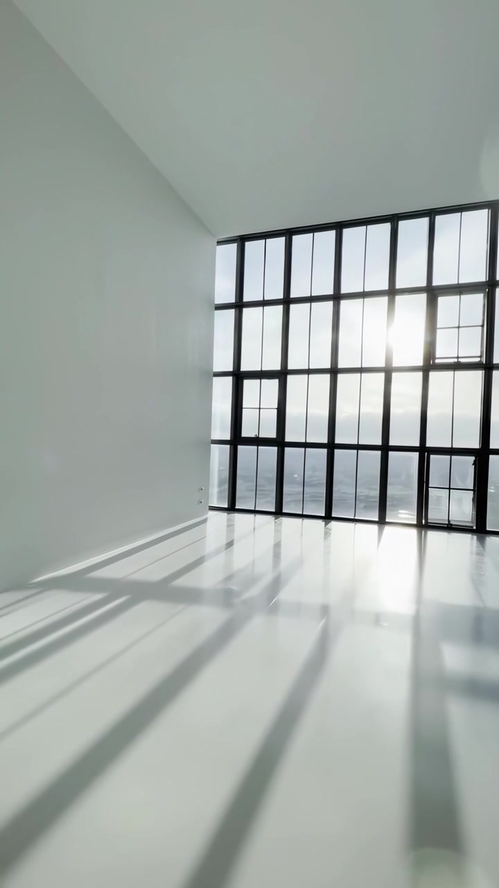 Sunlight Streaming Through Large Windows in Empty Modern Room