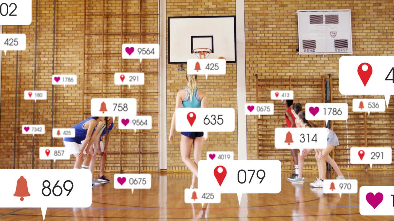 Practicing basketball in gym, players using animation for social media notifications