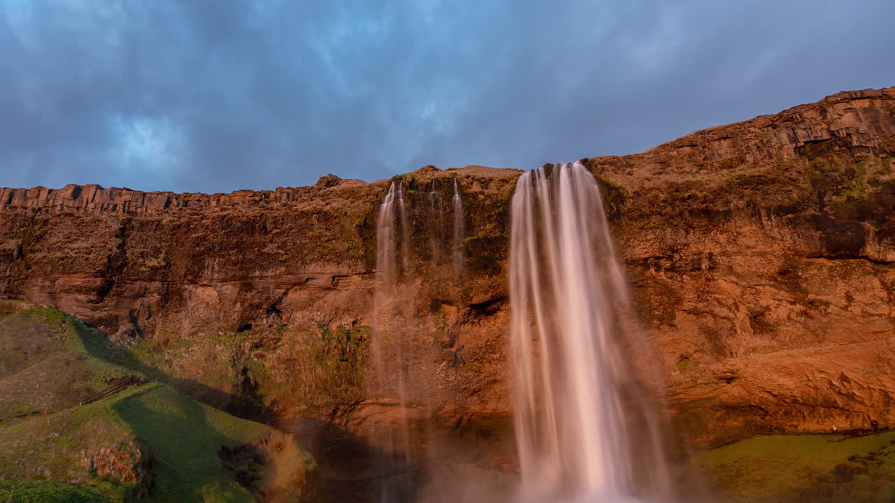 Timelapse of Seljalandfoss Waterfall, Iceland. Dramatic Sky And Water Falls Over Volcanic Cliff