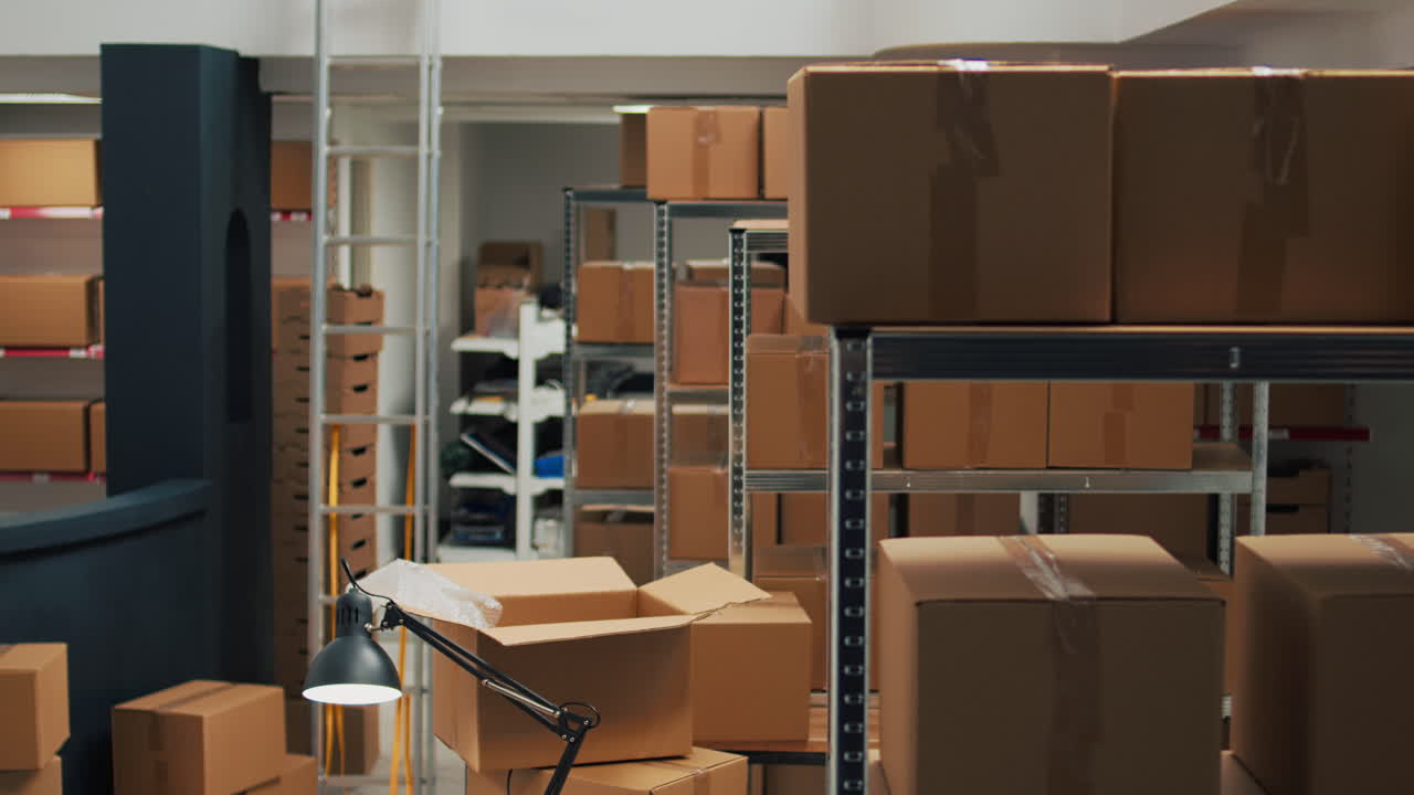 Warehouse with boxes on shelves and desk with equipment