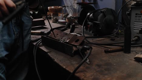 Cose-up-shot-of-mechanic-welding-scrap-metal-in-his-garage