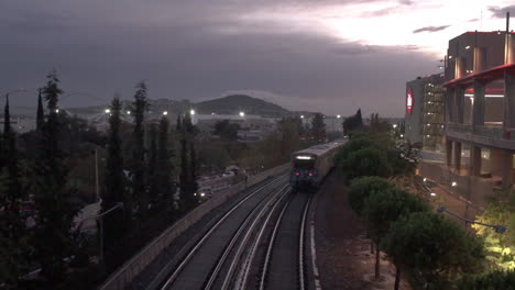 electric transportation train passes by next to biggest mall of greece, the mall athens