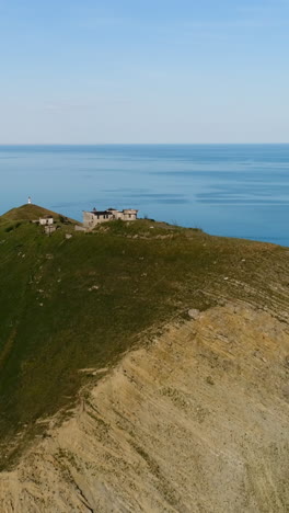 aerial view of abandoned military buildings on a coastal hill