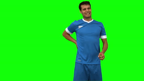 football player suffering from back pain on green screen