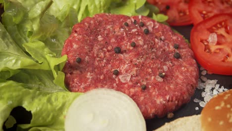 fresh beef for burger on the table with lettuce onion and bread