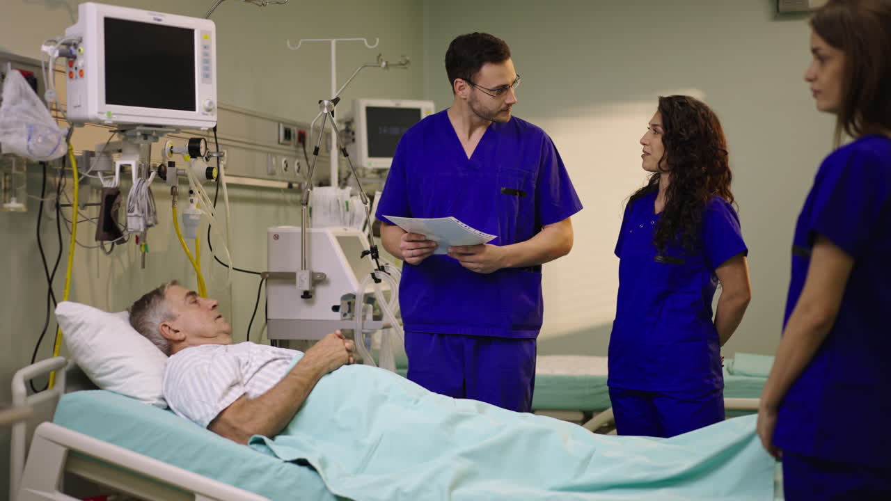 Medical staff attending to patient in hospital bed
