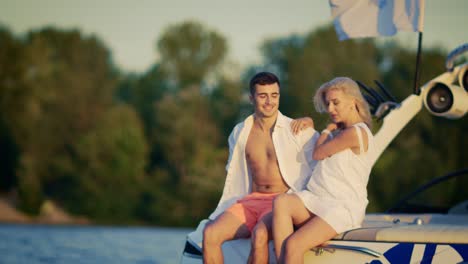 happy married couple in love resting together on yacht