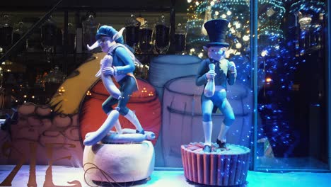 christmas window display with elves and pigs