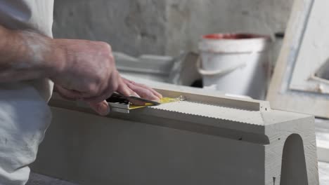 craftsman hands working with gypsum piece in his workshop