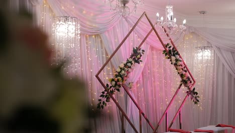 Flowers-Hanging-From-An-Arch-During-Wedding-Ceremony---Wide-Shot