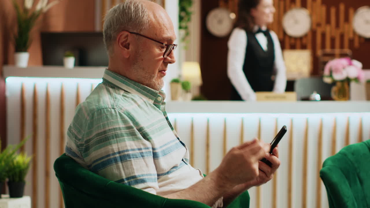 Retired man checking smartphone app