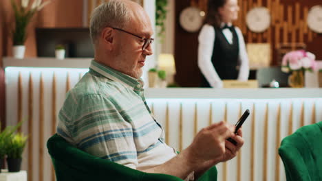 retired man checking smartphone app