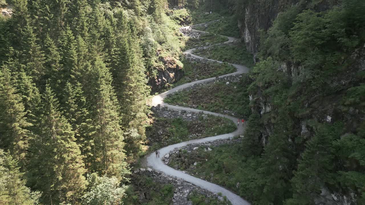 Drone Flight at Kossdalssvingene with People walking on Trail on a Sunny Warm Day in Oster&oslash;y, Norway
