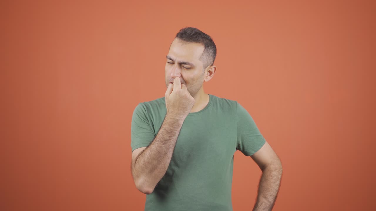 Stressed businessman biting nails.