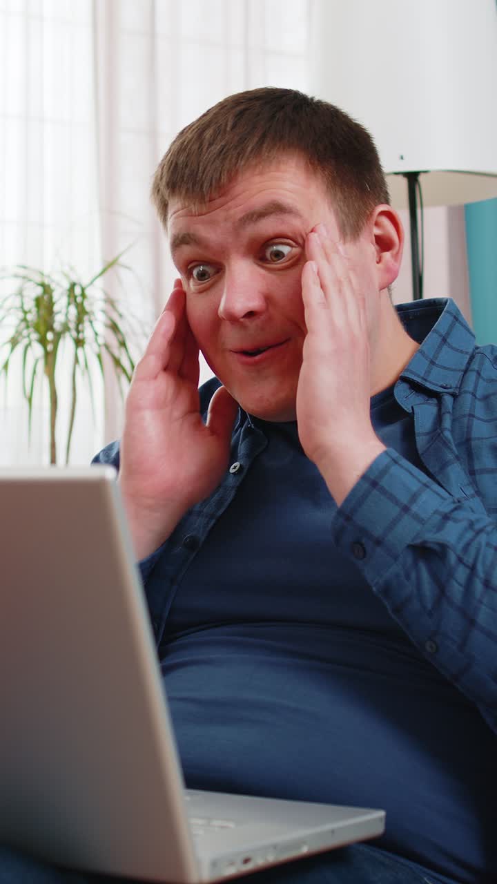 Surprised amazed man using laptop computer receive mail good news message wow shocked win app game