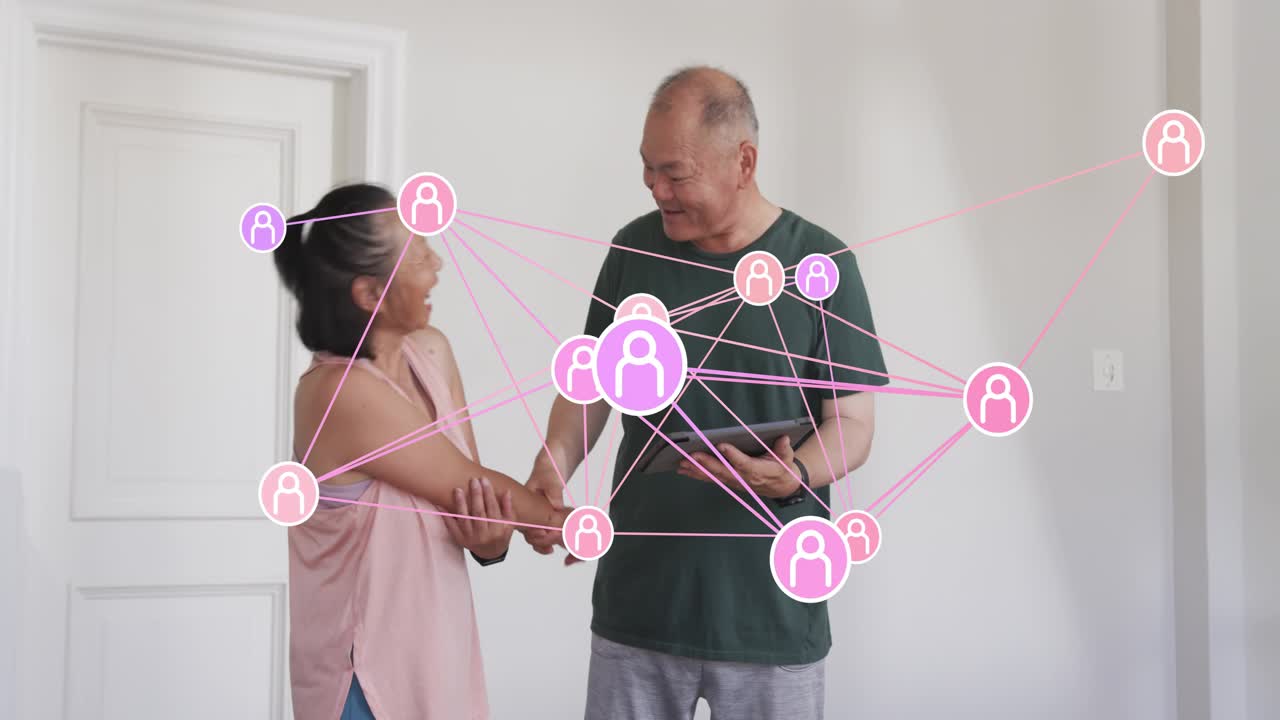 Senior woman moving arms triggers man holding tablet guiding arms, overlay tracking for rehab