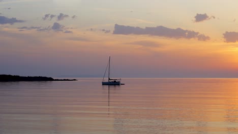 lonely boat moored in sea at sunset