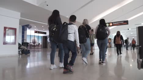 people walking inside an airport.