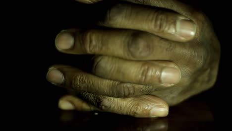 man-praying-to-god-with-hands-together-on-black-background-with-people-stock-video