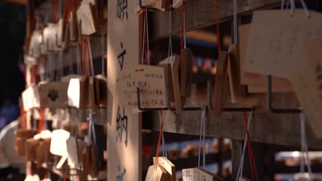 Slow-Motion-close-up-rotating-shot-of-wooden-wishing-cards-at-Japanese-Shrine